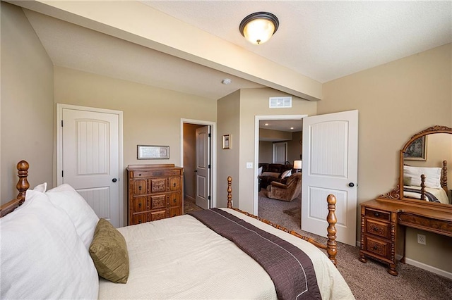 bedroom featuring beam ceiling, carpet flooring, and visible vents