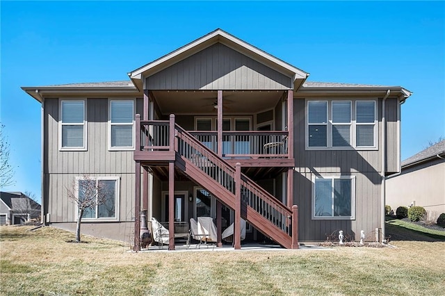 back of property with a yard, ceiling fan, a patio, and stairs