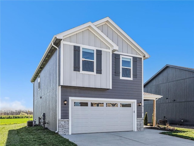 view of front of home featuring board and batten siding, stone siding, driveway, and an attached garage