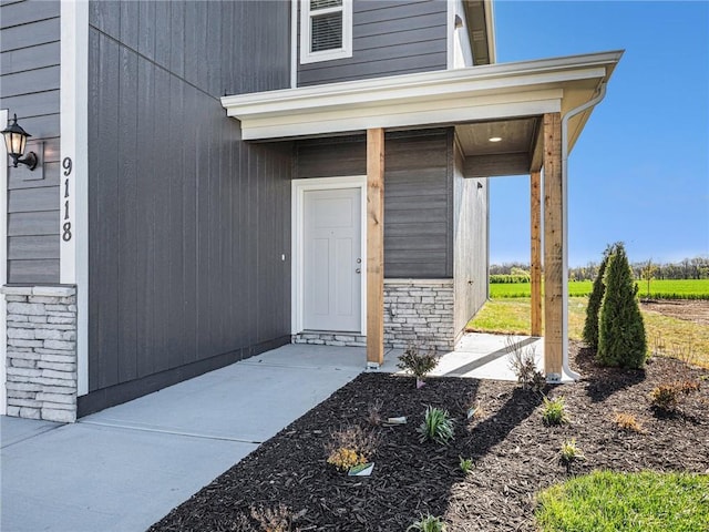 entrance to property featuring stone siding