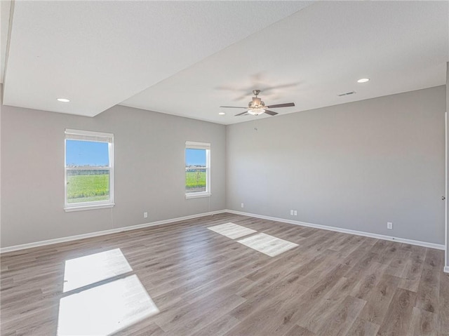 empty room featuring visible vents, baseboards, light wood-style flooring, ceiling fan, and recessed lighting