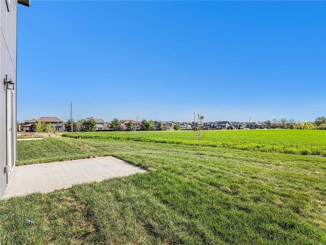 view of yard with a rural view