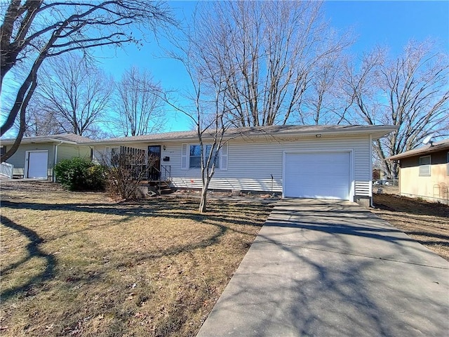 ranch-style house with a garage and driveway