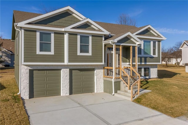 split foyer home with concrete driveway, roof with shingles, an attached garage, and a front lawn