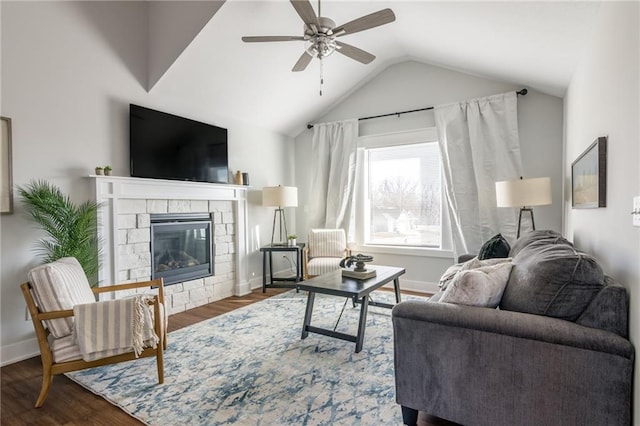 living room with a fireplace, vaulted ceiling, wood finished floors, and baseboards