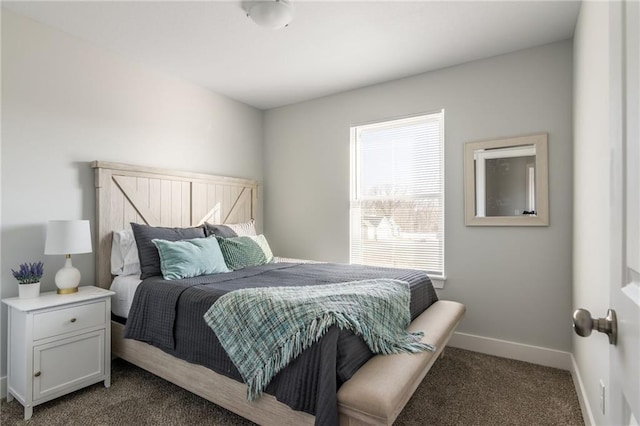 bedroom with baseboards and dark carpet