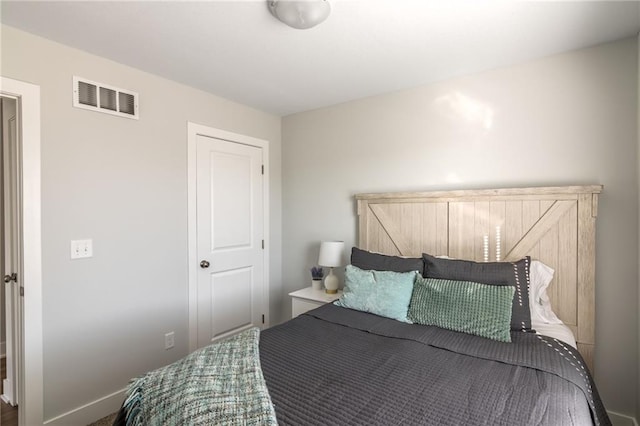 bedroom with visible vents and baseboards