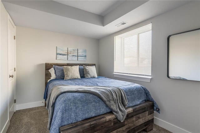 carpeted bedroom with visible vents and baseboards