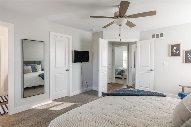 bedroom with carpet, baseboards, visible vents, and a ceiling fan