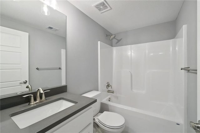 full bath with visible vents, shower / tub combination, vanity, and toilet