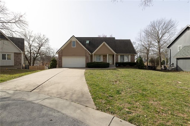 view of front of home with brick siding, a garage, driveway, and a front lawn