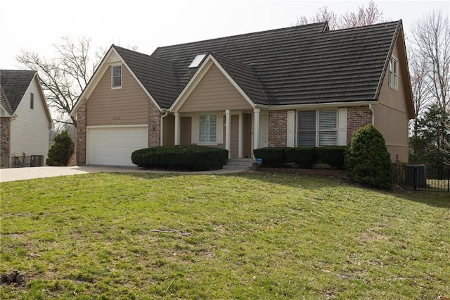 view of front of home featuring a garage, driveway, brick siding, and a front yard