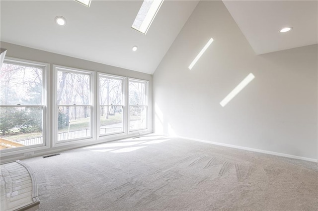 unfurnished room with visible vents, recessed lighting, carpet floors, a skylight, and baseboards