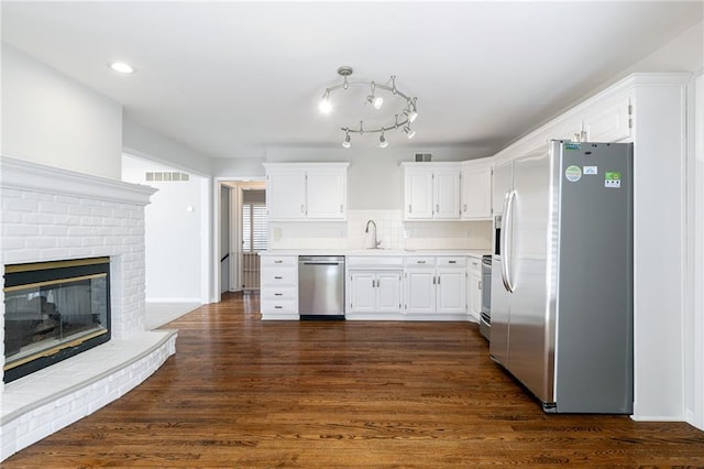 kitchen with white cabinetry, dark wood-type flooring, and appliances with stainless steel finishes