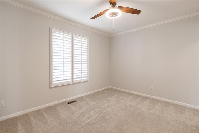 empty room featuring light carpet, baseboards, a ceiling fan, and ornamental molding