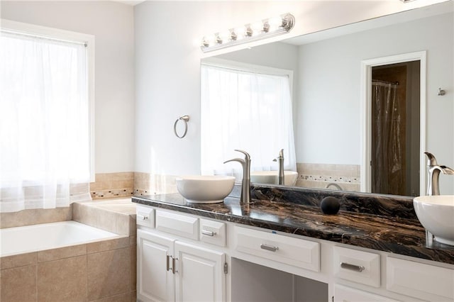 full bath with a shower with curtain, double vanity, a bath, and a sink