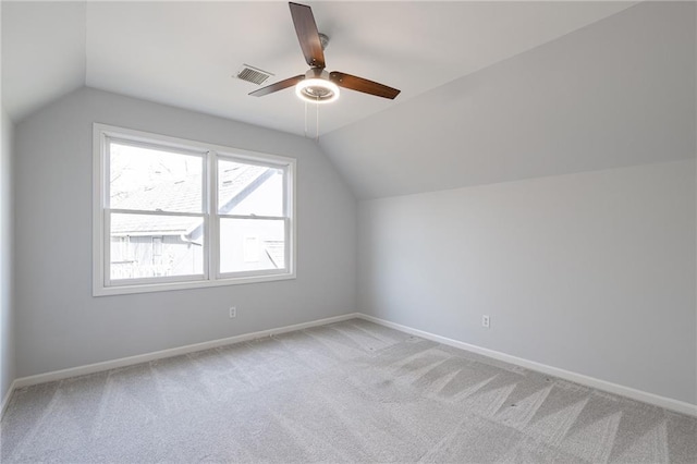 bonus room with visible vents, light carpet, baseboards, and vaulted ceiling