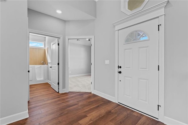 foyer entrance featuring dark wood-style flooring and baseboards