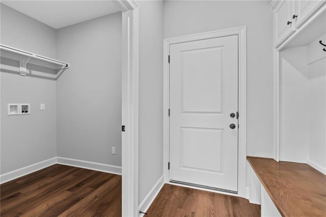 clothes washing area featuring dark wood-style floors, baseboards, and washer hookup