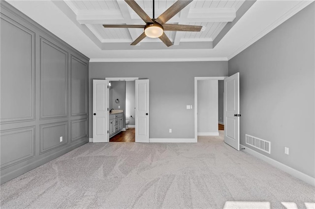 unfurnished bedroom with ornamental molding, carpet floors, beam ceiling, and visible vents