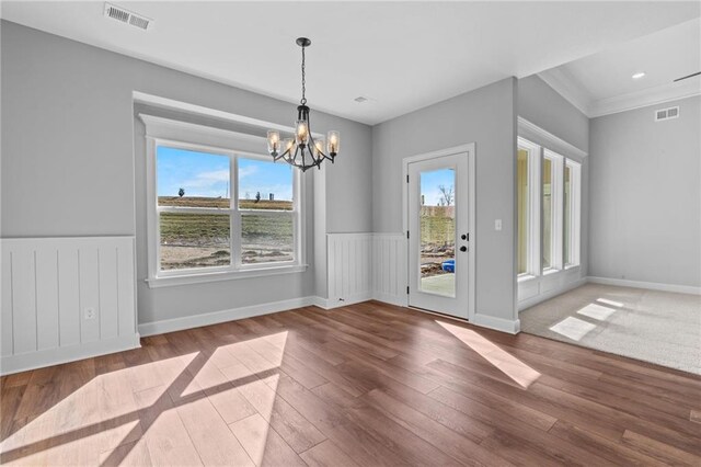 2409 Merlot Pl, Excelsior Springs, MO 64024 - unfurnished dining area with a chandelier, hardwood / wood-style floors, a wainscoted wall, and ornamental molding
