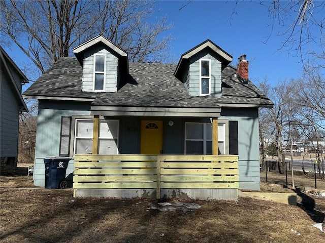 view of front of home with covered porch and a chimney