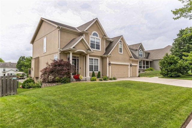 view of front of property featuring an attached garage, fence, concrete driveway, and a front yard