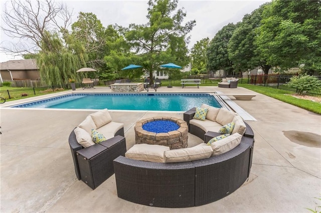 view of pool with a fenced backyard, a patio area, an outdoor living space with a fire pit, and a fenced in pool