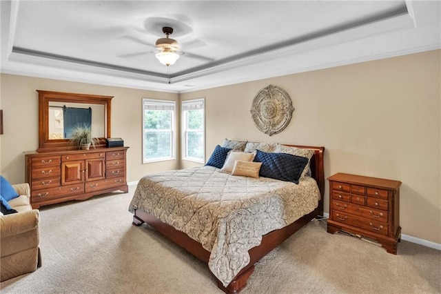 bedroom with carpet floors, a raised ceiling, ceiling fan, and baseboards