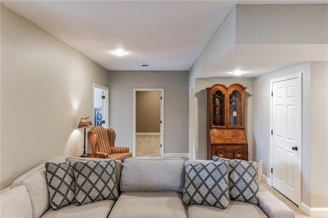 carpeted living room featuring baseboards