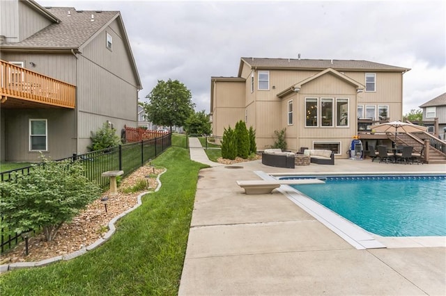 view of pool with a patio, fence, an outdoor living space, stairs, and a diving board