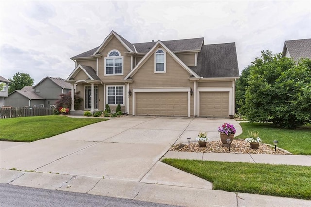 view of front of house with a garage, concrete driveway, fence, and a front lawn