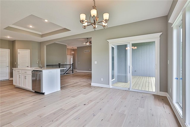 kitchen featuring a center island with sink, dishwasher, light wood-style flooring, light countertops, and white cabinetry