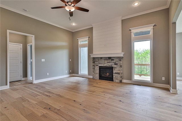 unfurnished living room with light wood-style floors, baseboards, crown molding, and ceiling fan
