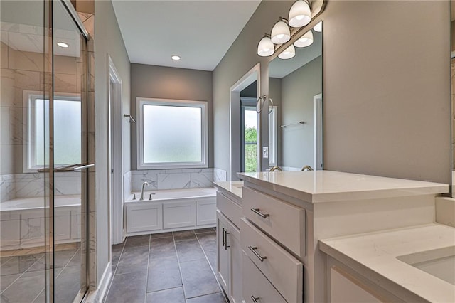 full bath with a bath, tile patterned flooring, two vanities, and a stall shower