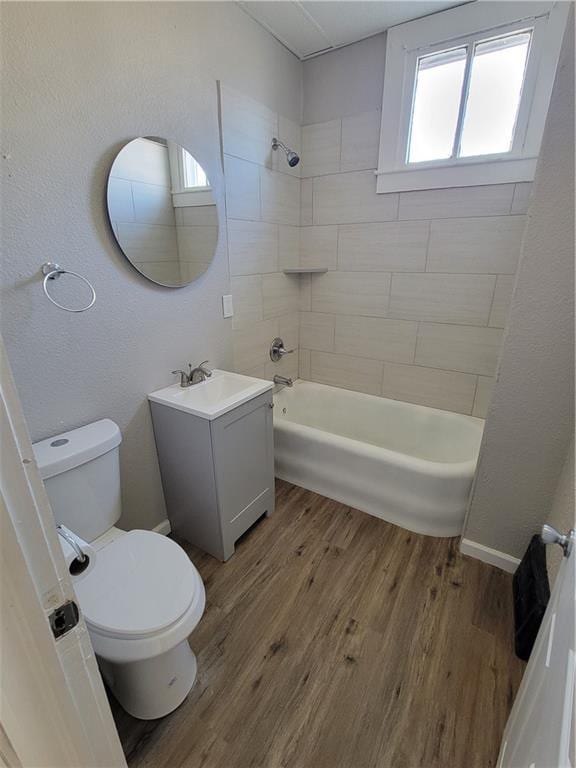 full bathroom featuring toilet, shower / bathtub combination, wood finished floors, and vanity