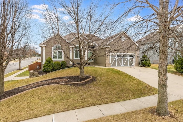 view of front of home with a garage, stucco siding, concrete driveway, and a front lawn