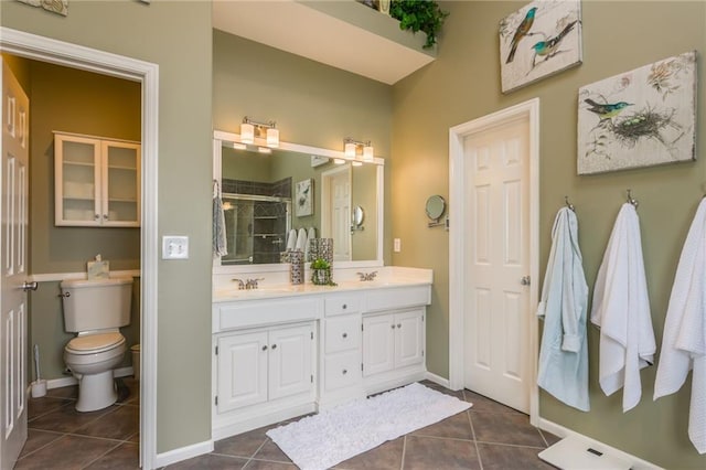 bathroom with toilet, double vanity, a stall shower, tile patterned floors, and a sink