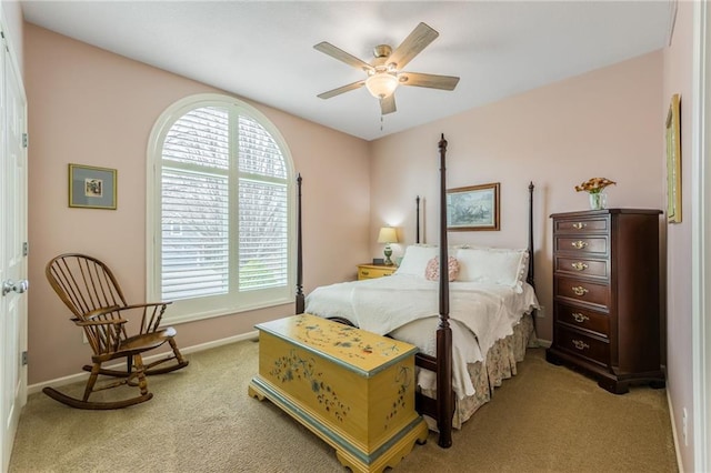 bedroom with baseboards, light colored carpet, and a ceiling fan