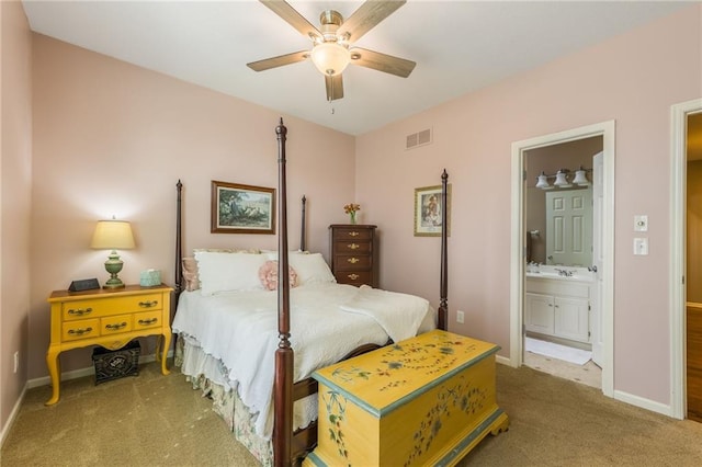 bedroom featuring carpet flooring, baseboards, visible vents, and ensuite bathroom