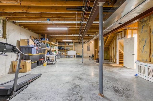 unfinished basement featuring stairs