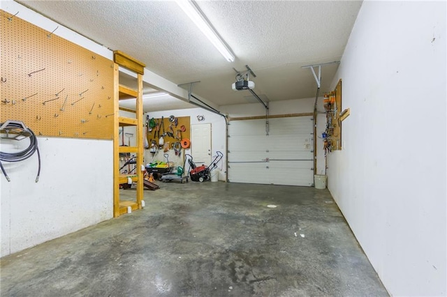 garage with a workshop area and a garage door opener