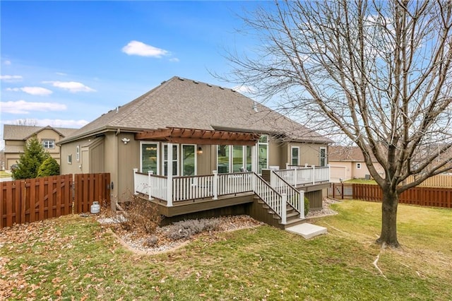 back of house featuring a wooden deck, roof with shingles, a yard, a fenced backyard, and a pergola