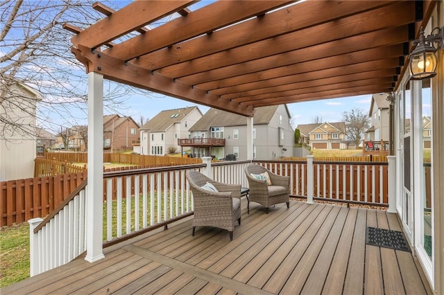 wooden deck with a residential view, fence, and a pergola