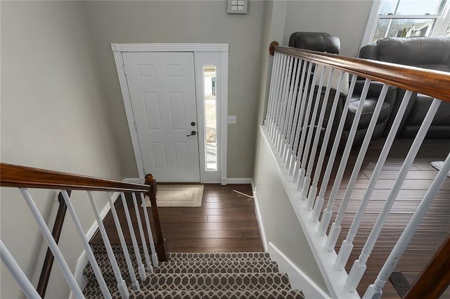 foyer entrance featuring stairway, wood finished floors, and baseboards