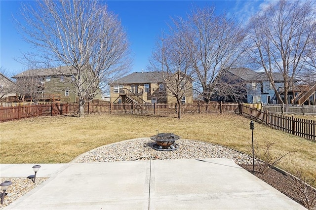 view of yard featuring a fire pit, a patio, and a fenced backyard