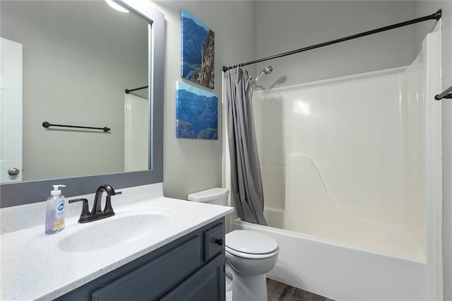 full bath with shower / tub combo, vanity, toilet, and wood finished floors