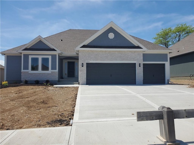 10216 N Winchester Ave, Kansas City, MO 64156 - view of front facade with an attached garage, driveway, and roof with shingles