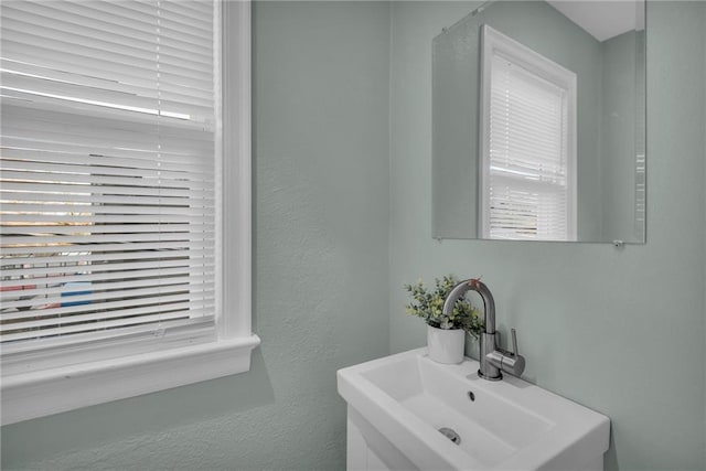 bathroom with a sink and a textured wall