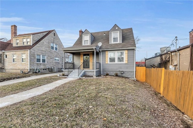 936 E Gregory Blvd, Kansas City, MO 64131 - view of front of house with a chimney, covered porch, and roof with shingles